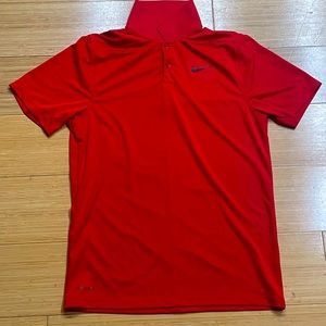Medium red Nike polo.
